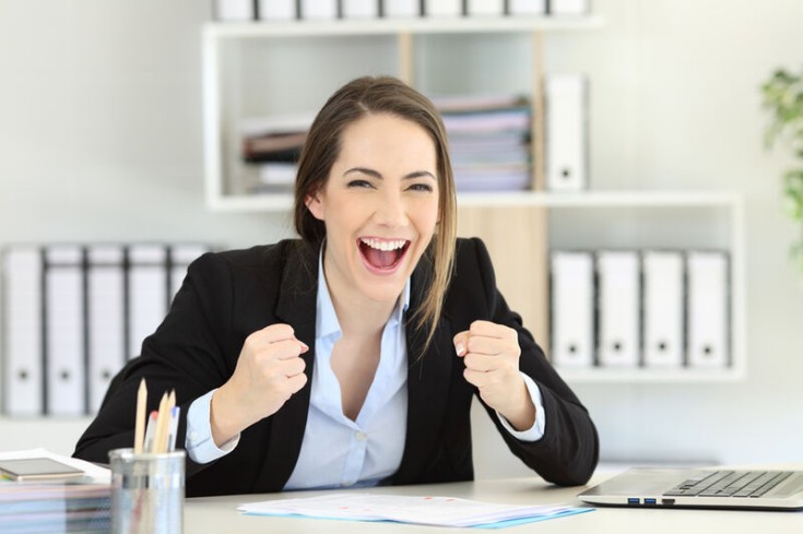 Front view portrait of a woman looking at camera at office