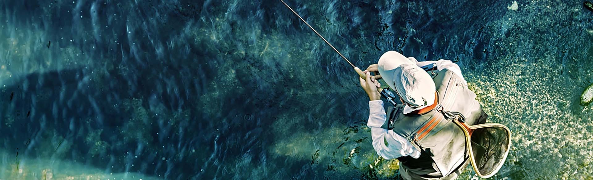 Fly fisherman using flyfishing rod in beautiful river.